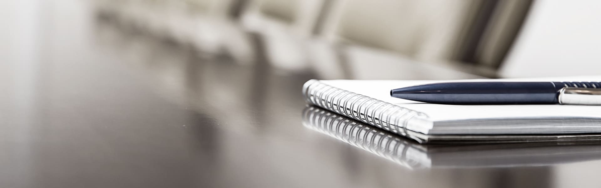 pen on notepad on boardroom desk