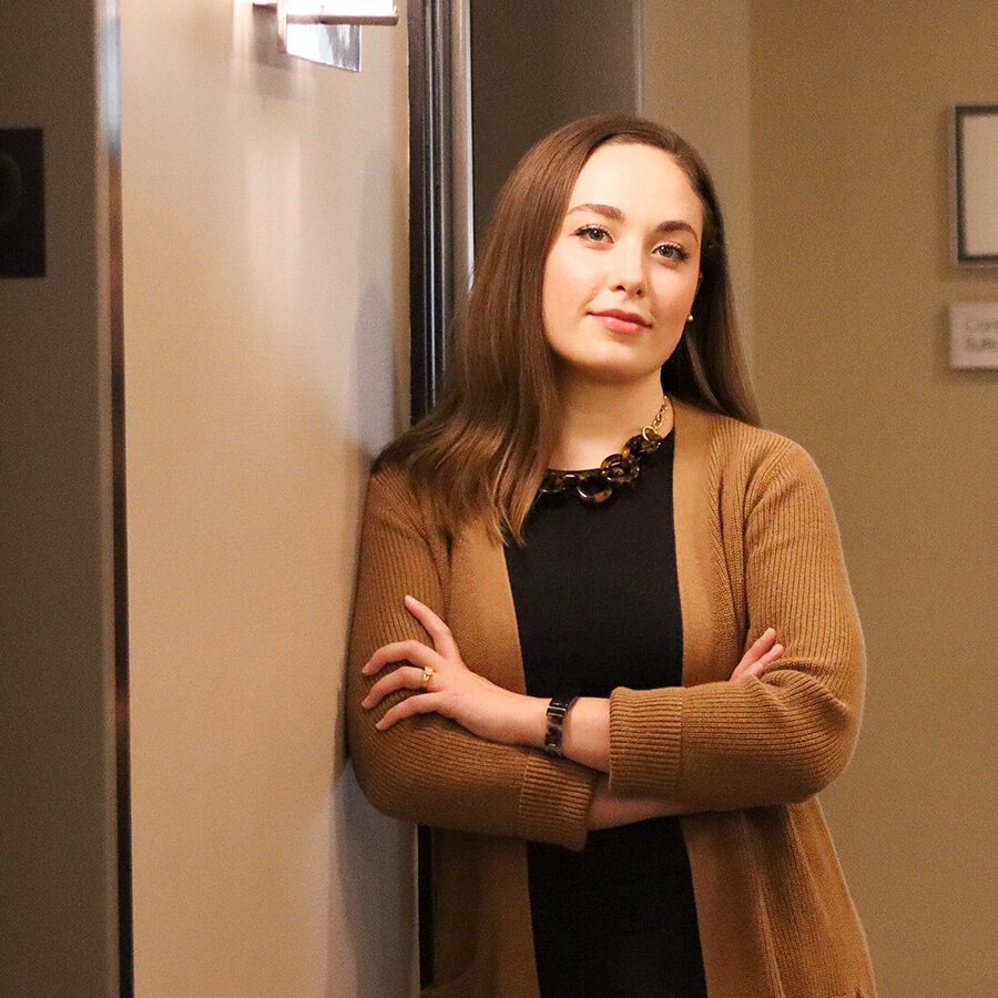 Woman leaning against the wall and posing