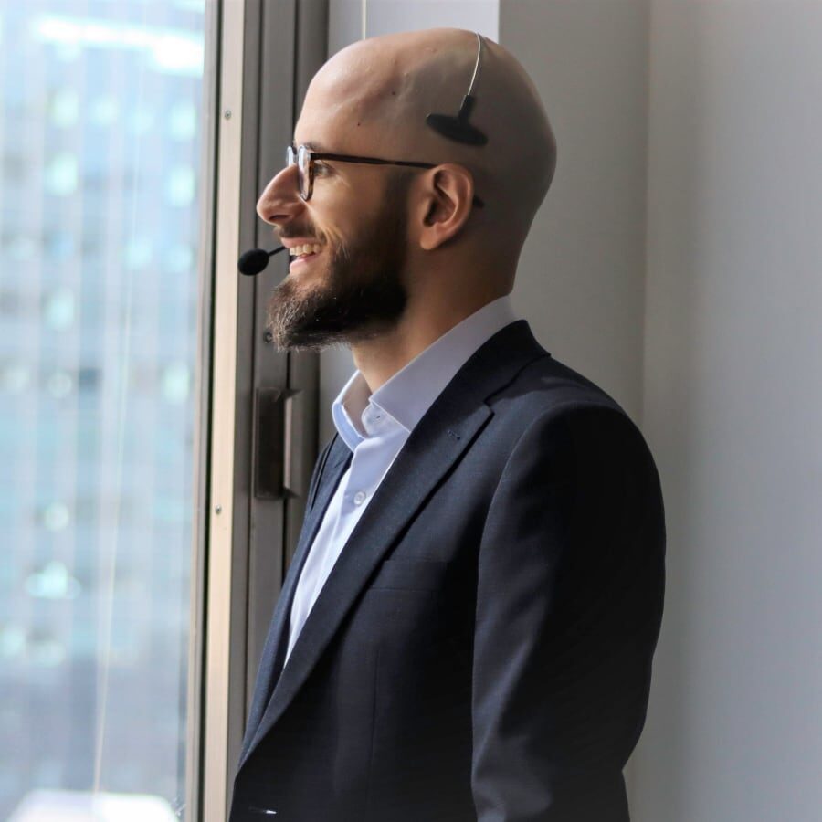 Man wearing a headset looking out a window