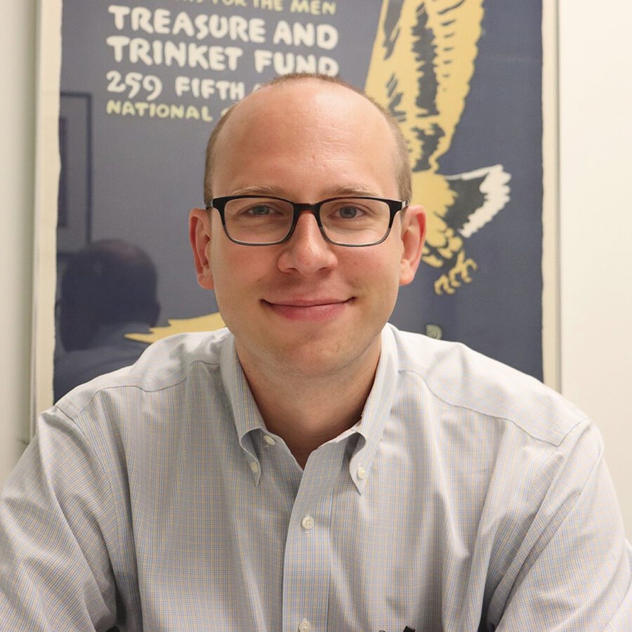 A man is smiling and posing for the camera