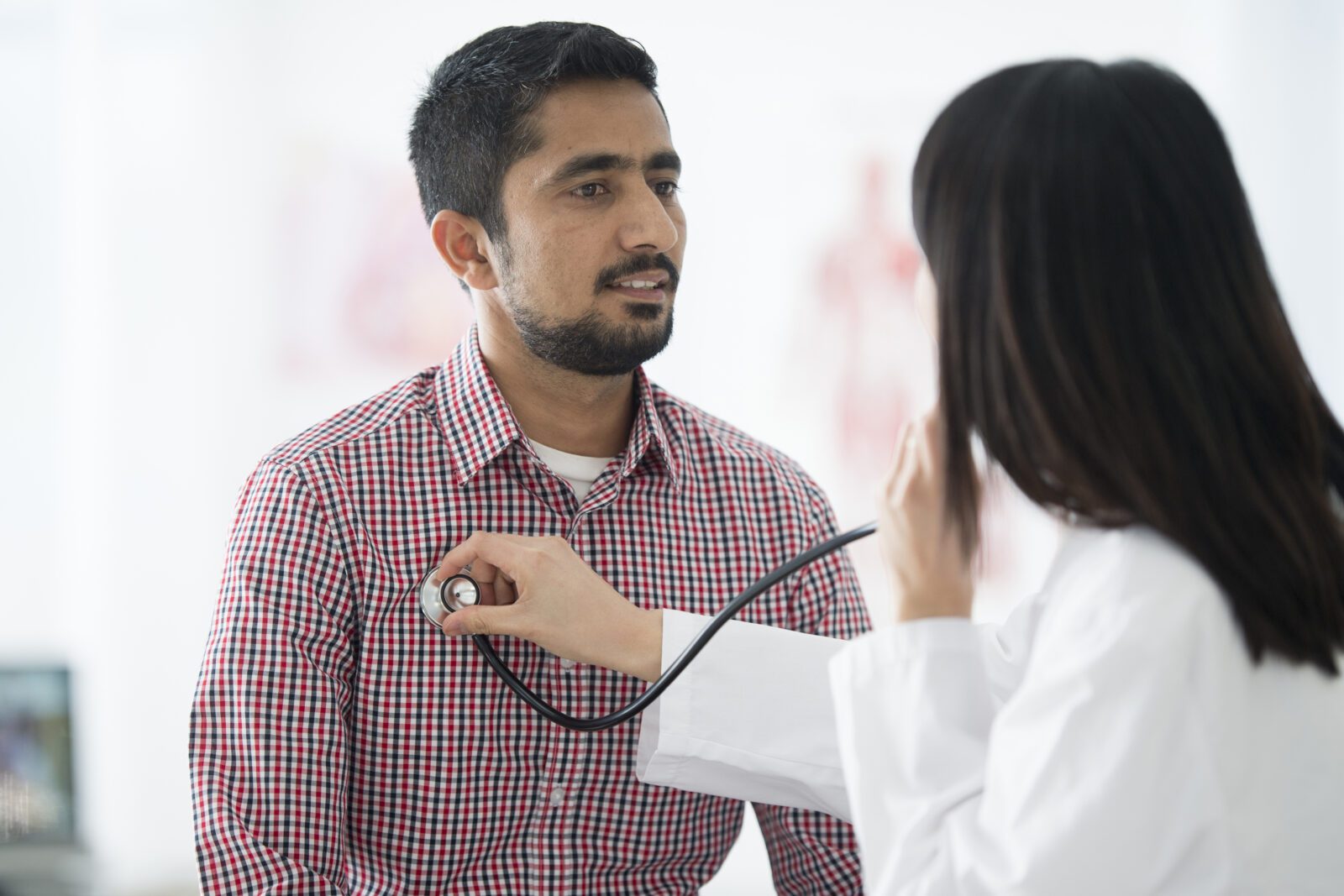 A man is getting an annual check up at the doctors office.
