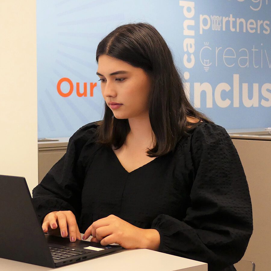 A woman is working on a laptop
