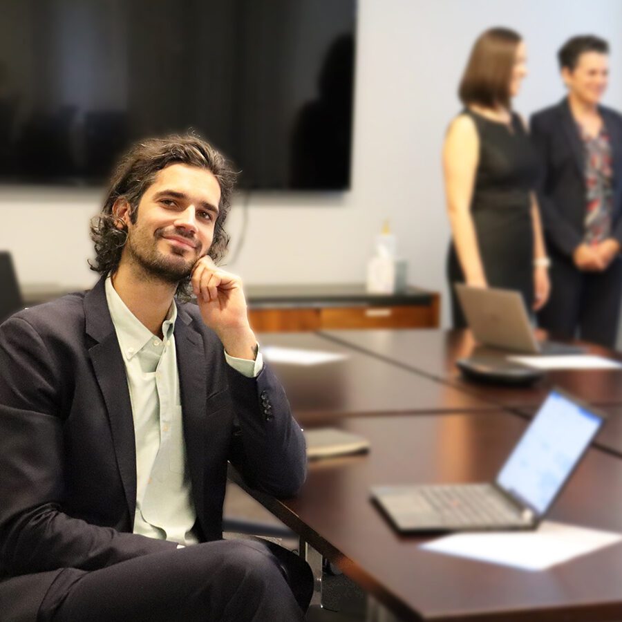 A man is sitting in a large conference room