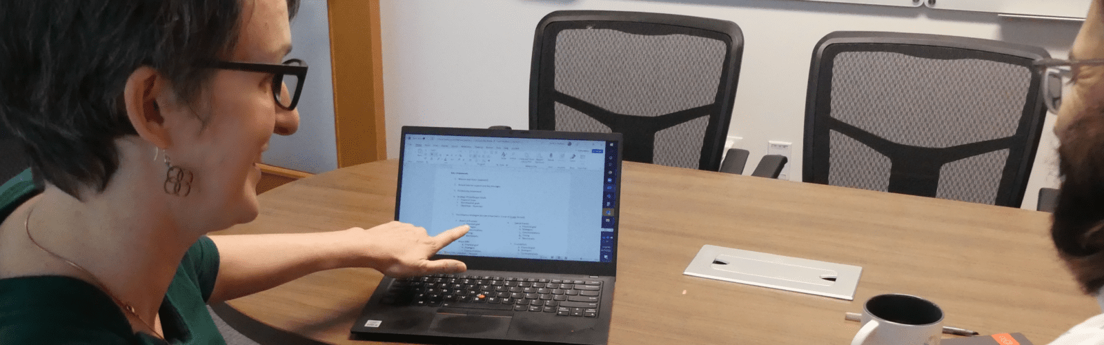Business woman pointing to computer